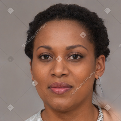 Joyful black adult female with short  brown hair and brown eyes