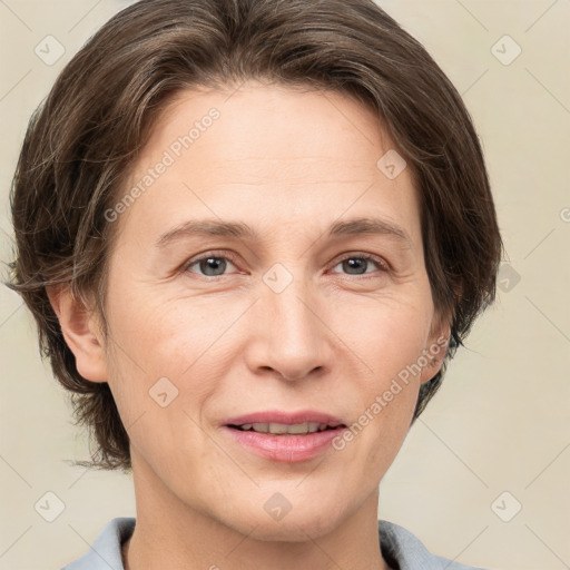 Joyful white adult female with medium  brown hair and grey eyes