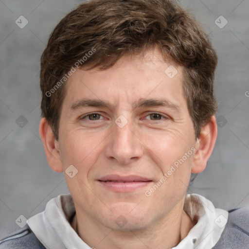 Joyful white adult male with short  brown hair and grey eyes