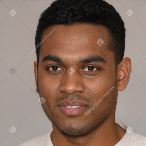 Joyful black young-adult male with short  black hair and brown eyes