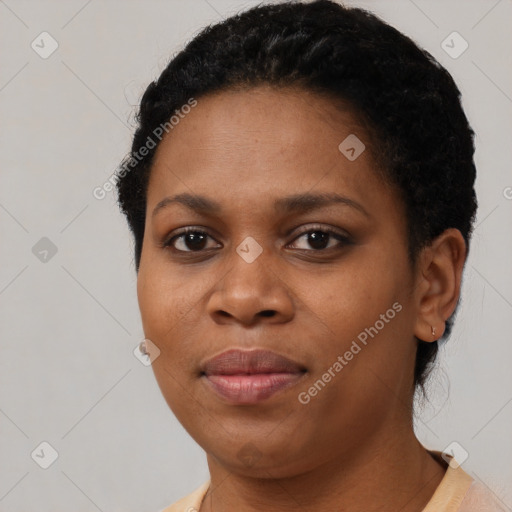 Joyful black young-adult female with short  black hair and brown eyes