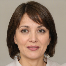 Joyful white adult female with medium  brown hair and brown eyes