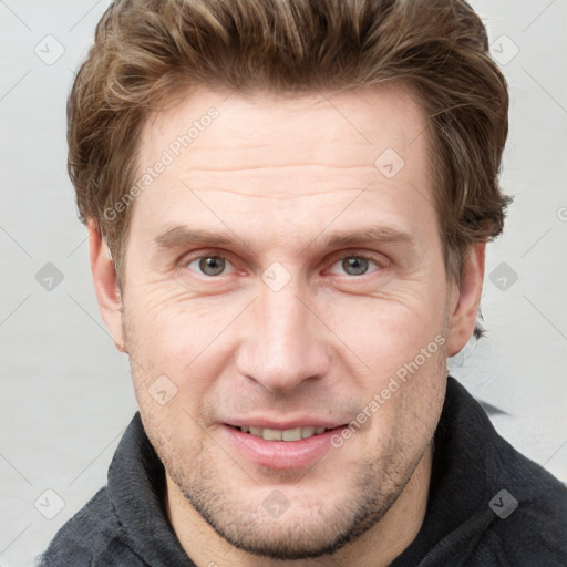 Joyful white adult male with short  brown hair and grey eyes