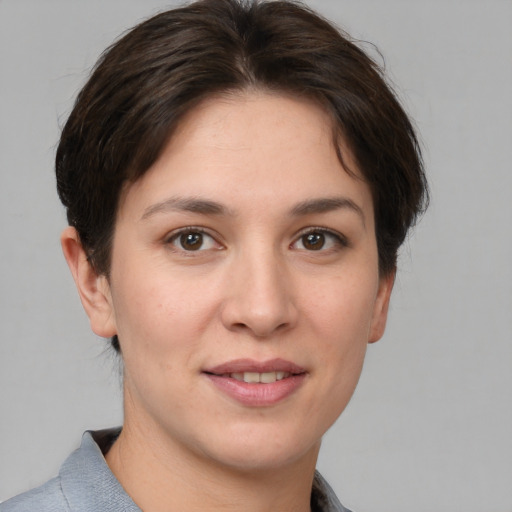 Joyful white young-adult female with short  brown hair and grey eyes