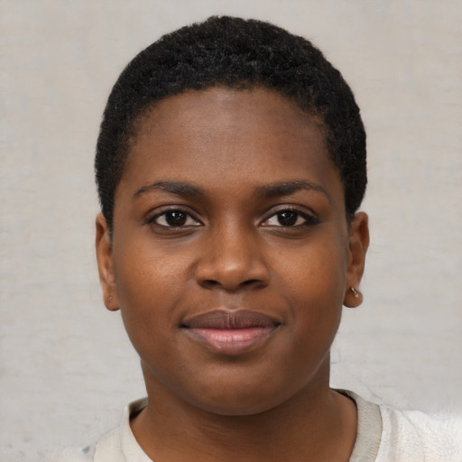 Joyful black young-adult female with short  brown hair and brown eyes