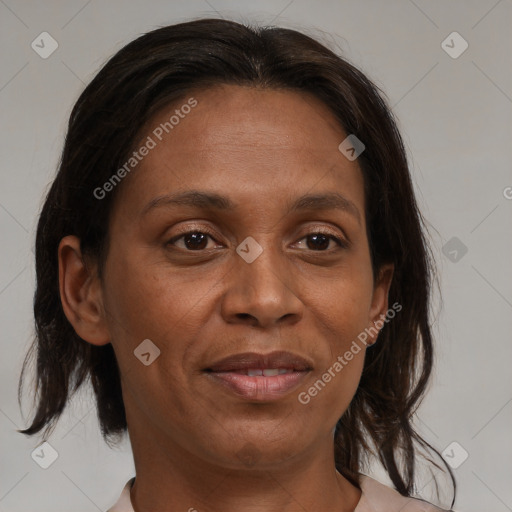 Joyful black adult female with medium  brown hair and brown eyes