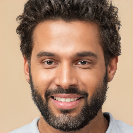 Joyful white young-adult male with short  black hair and brown eyes