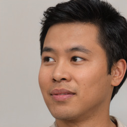 Joyful white young-adult male with short  black hair and brown eyes