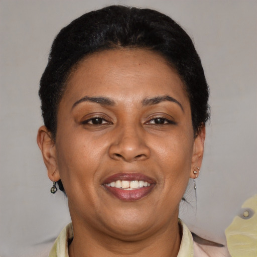 Joyful latino adult female with short  brown hair and brown eyes