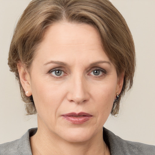 Joyful white adult female with medium  brown hair and grey eyes