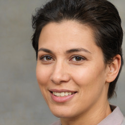 Joyful white adult female with medium  brown hair and brown eyes