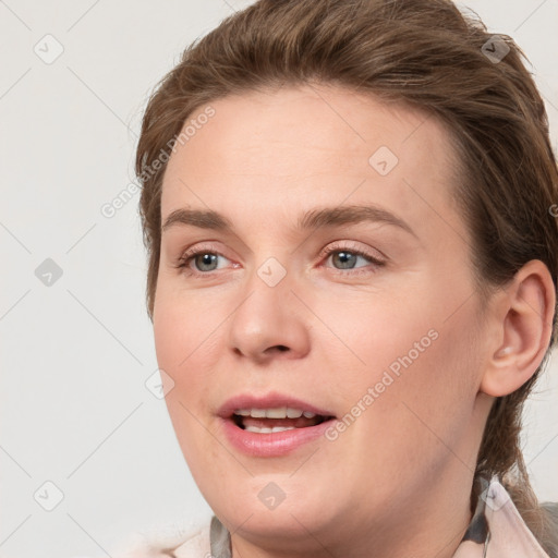 Joyful white young-adult female with medium  brown hair and grey eyes