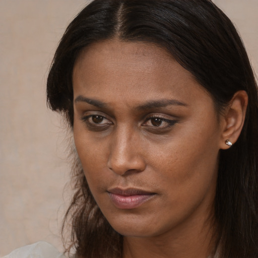 Neutral black young-adult female with long  brown hair and brown eyes