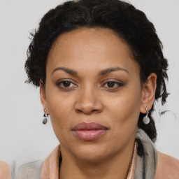 Joyful black adult female with short  brown hair and brown eyes