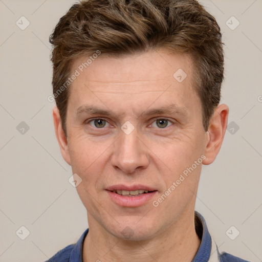 Joyful white adult male with short  brown hair and grey eyes