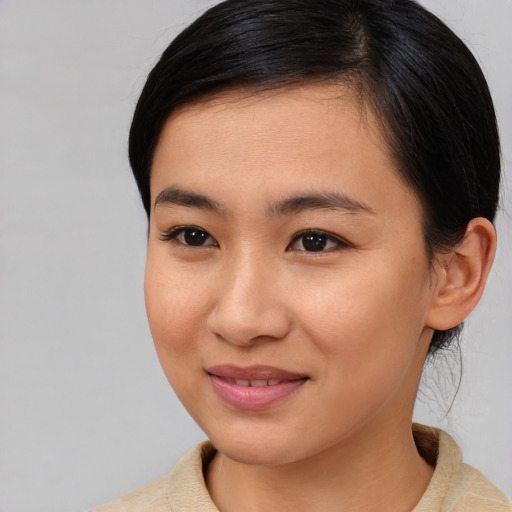 Joyful asian young-adult female with medium  brown hair and brown eyes