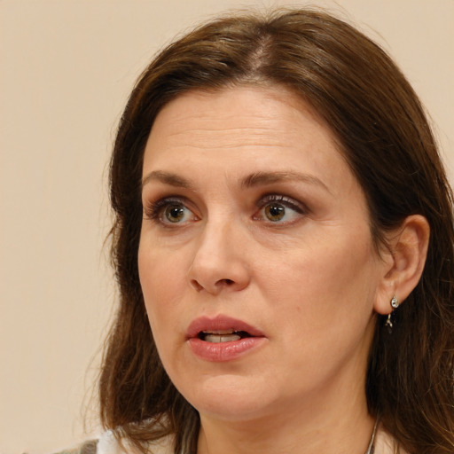 Joyful white adult female with long  brown hair and brown eyes