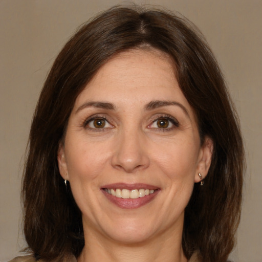 Joyful white adult female with medium  brown hair and brown eyes