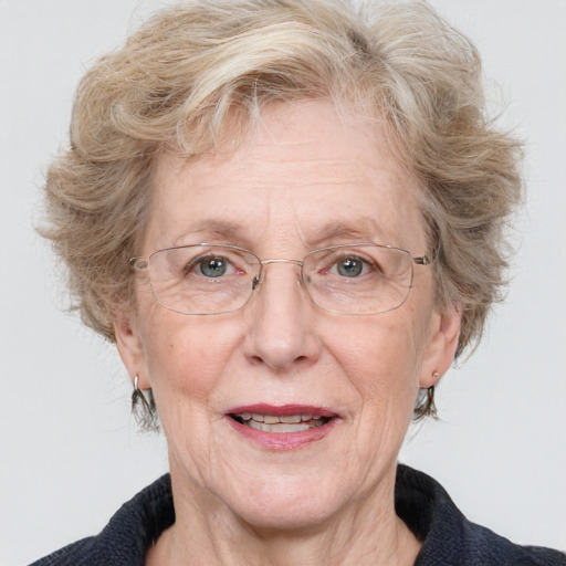 Joyful white middle-aged female with medium  brown hair and blue eyes