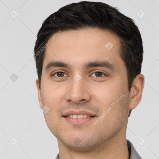 Joyful white young-adult male with short  black hair and brown eyes