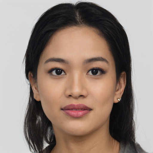 Joyful asian young-adult female with long  black hair and brown eyes