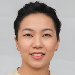 Joyful asian young-adult female with short  brown hair and brown eyes