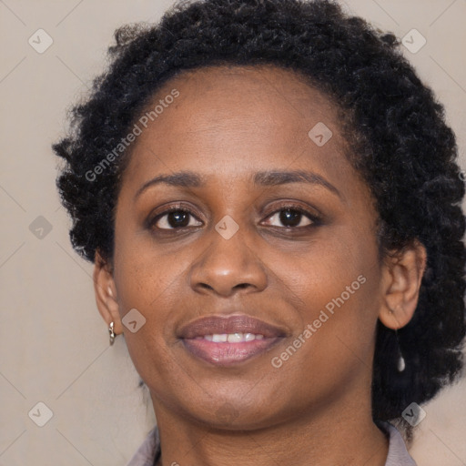 Joyful black adult female with long  brown hair and brown eyes