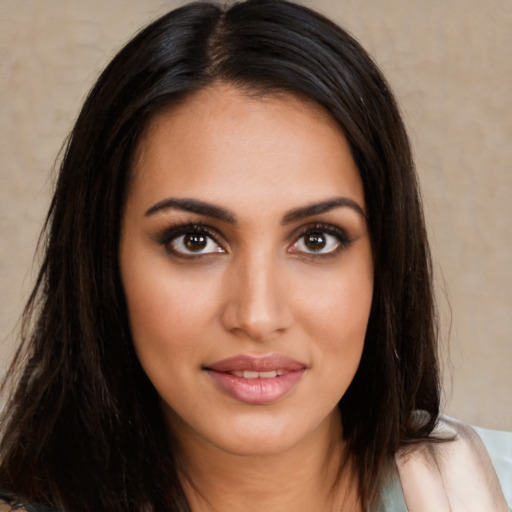 Joyful latino young-adult female with long  brown hair and brown eyes