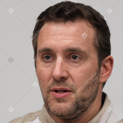 Joyful white adult male with short  brown hair and brown eyes