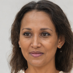 Joyful black adult female with medium  brown hair and brown eyes