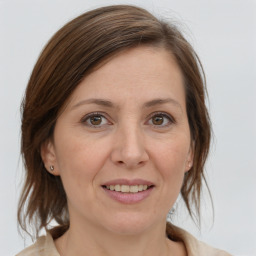 Joyful white adult female with medium  brown hair and grey eyes