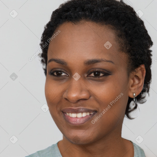 Joyful black young-adult female with short  black hair and brown eyes