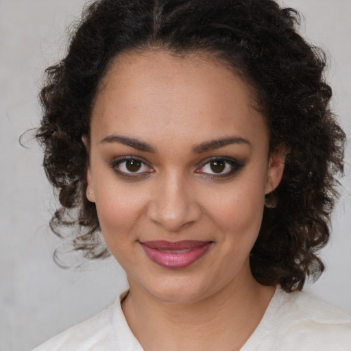 Joyful black young-adult female with medium  brown hair and brown eyes