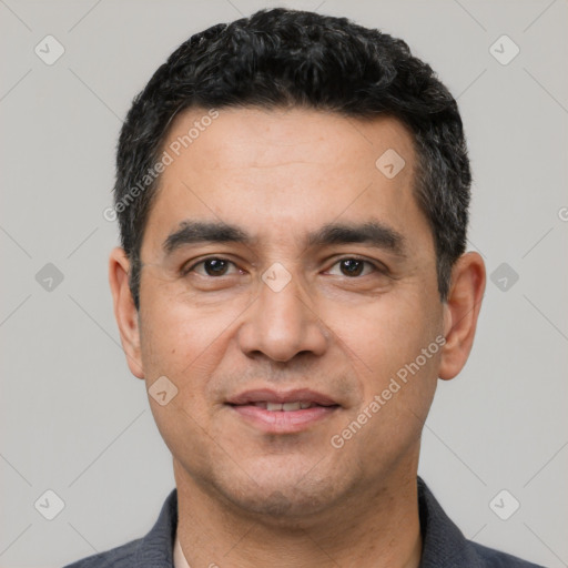 Joyful white adult male with short  black hair and brown eyes