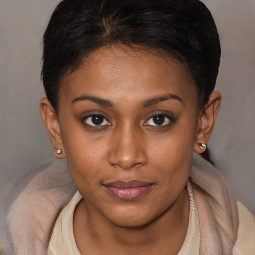 Joyful black young-adult female with short  brown hair and brown eyes