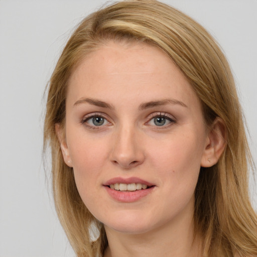 Joyful white young-adult female with long  brown hair and blue eyes