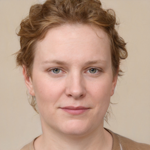 Joyful white young-adult female with medium  brown hair and blue eyes