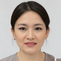 Joyful asian young-adult female with medium  brown hair and brown eyes