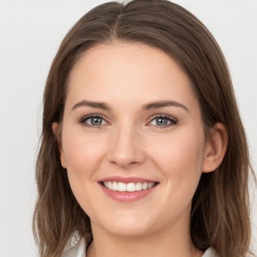 Joyful white young-adult female with long  brown hair and grey eyes