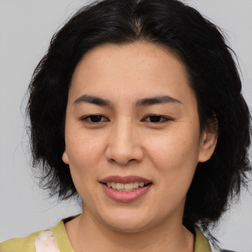 Joyful asian young-adult female with medium  black hair and brown eyes
