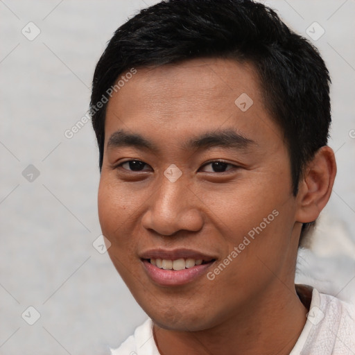 Joyful asian young-adult male with short  black hair and brown eyes