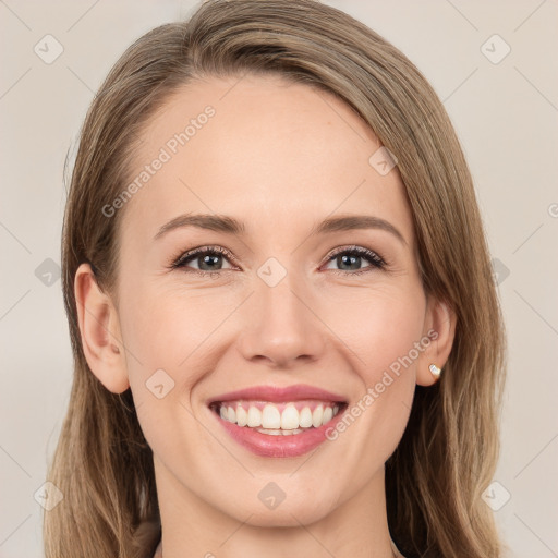 Joyful white young-adult female with long  brown hair and green eyes