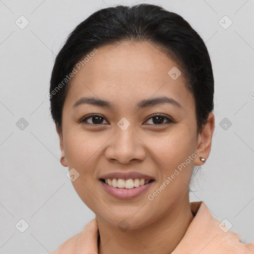 Joyful latino young-adult female with short  black hair and brown eyes