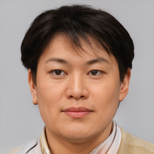 Joyful asian adult female with short  brown hair and brown eyes