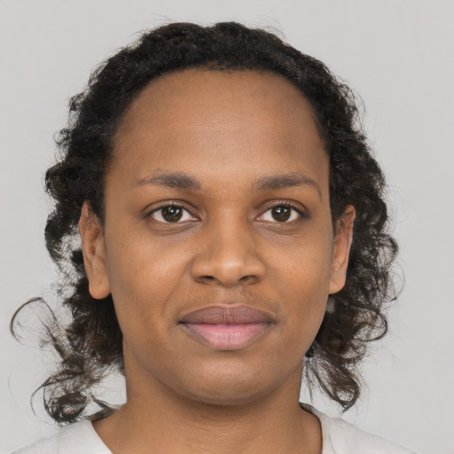 Joyful black young-adult female with medium  brown hair and brown eyes