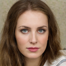 Joyful white young-adult female with long  brown hair and green eyes