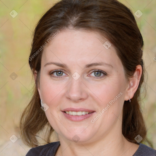 Joyful white adult female with medium  brown hair and blue eyes