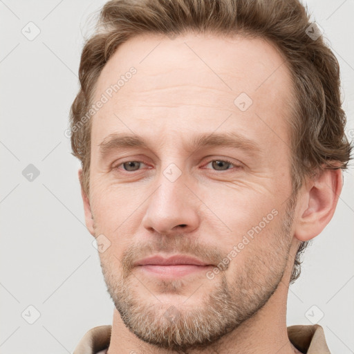 Joyful white adult male with short  brown hair and grey eyes