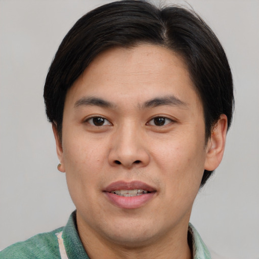 Joyful asian young-adult male with short  brown hair and brown eyes