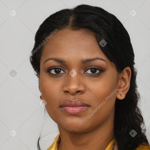 Joyful black young-adult female with long  black hair and brown eyes